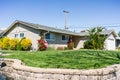 Exterior view of single-family detached home on a corner lot in a residential neighborhood; South San Francisco Bay Area, Royalty Free Stock Photo