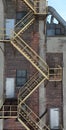 Exterior view of a tall brick building, featuring a fire escape staircase. Fort William, Ontario. Royalty Free Stock Photo
