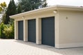 Exterior view of a three-car garage with mint green doors. Royalty Free Stock Photo