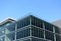 Exterior view of a vacant brand new modern office building. Typical glass facade of generic modern commercial building. Blue sky.