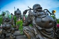 Smiling happy buddhist statues against blue sky at Viharn Sien temple