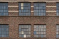 old brick factory wall and windows in city