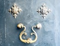 Exterior vintage door knocker metal circle on a wooden door of an ancient building in Catania, Sicily, Italy Royalty Free Stock Photo