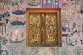 Exterior wall with beautiful mosaic and gold painted window of the pavilion at Xieng Thong temple in Luang Prabang, Laos. Royalty Free Stock Photo