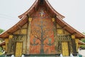 Exterior wall with beautiful tree mosaic of the pavilion at Xieng Thong temple in Luang Prabang, Laos.