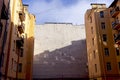 Exterior wall of a house with reflections of windows in an old courtyard