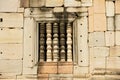 Exterior wall with a window at the ruins of the Hindu temple in Phimai historical park Prasat Hin Phimai in Thailand.