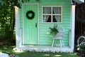 Exterior Wooden porch home with garden furniture. Facade green wooden house decorated for spring holidays