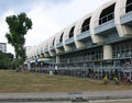 The exteriors of the Aljunided Subway Station in Geylang in Singapore. Modern architecture. Adjacent park with lush greenery.