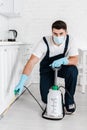 Exterminator in uniform holding toxic spray Royalty Free Stock Photo