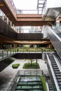 External Courtyard of a Retail Complex with Escalator on Landscape Terraces