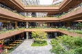 External Courtyard of a Retail Complex with Lush Greenery on Landscape Terraces