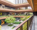 External Courtyard of a Retail Complex with Lush Greenery on Landscape Terraces