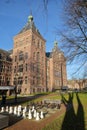 The external facade of Tropenmuseum in Amsterdam, with a giant chess game in the foreground