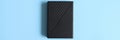 external hard drive black color on blue background. space for text. banner.