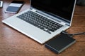 An external hard drive connected to the laptop with a usb cable Royalty Free Stock Photo