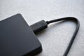 External hard drive with usb cable on a gray background Royalty Free Stock Photo