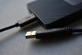 External hard drive with usb cable on a gray background Royalty Free Stock Photo