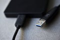 External hard drive with usb cable on a gray background Royalty Free Stock Photo