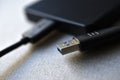 External hard drive with usb cable on a gray background Royalty Free Stock Photo