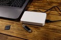 External HDD connected to laptop computer, SD memory card and USB flash drive on wooden desk. Concept of data storage Royalty Free Stock Photo