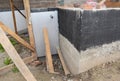 External house basement foundation wall insulation with rigid foam board before waterproofing