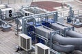 External infrastructure of the microclimate support system at a large industrial site. Air pipelines inlet and exhaust. Fans and Royalty Free Stock Photo