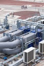 External infrastructure of the microclimate support system at a large industrial site. Air pipelines inlet and exhaust. Fans and Royalty Free Stock Photo