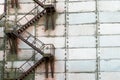 External metal staircase on the facade of an abandoned factory or enterprise building Royalty Free Stock Photo