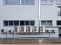 The external part of the air conditioner is located on the wall of the industrial premises. Ventilation device for air refreshment