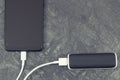 External powerbank charging empty battery of smartphone or mobile phone. Copy space for text