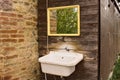 An external sink under a mirror in the garden of a farmhouse in the countryside Umbria, Italy