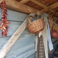 External storage room, dried peppers, onions, a wicker basket and a coat