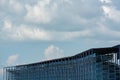 External view of grand stadium under construction with blue steel structure, bleachers and colorful on blue sky clouds with copy t