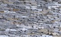 External wall coating made of bricks of natural gray, white and brown rocks. Full frame Royalty Free Stock Photo