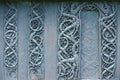 External wooden wall carved decoration of the medieval Urnes Stave church with viking motifs covered with tar in Ornes, Norway.