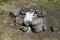 Extinct camp fire place with ashes surrounded with rocks or stones, photo of nature Royalty Free Stock Photo