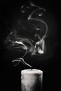 Extinct white candle with smoke on a black background Royalty Free Stock Photo