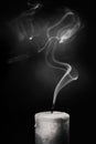 Extinct white candle with smoke on a black background Royalty Free Stock Photo