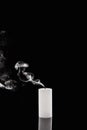 Extinct white candle with smoke on black background Royalty Free Stock Photo