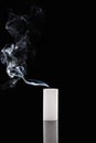 Extinct white candle with smoke on black background Royalty Free Stock Photo