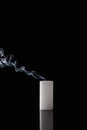 Extinct white candle with smoke on black background Royalty Free Stock Photo