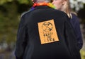 Extinction Rebellion Activist in the UK with a Rebel for Life sign pinned to the back of her coat