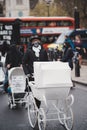 Extinction Rebellion activists marching slowly towards Downing Street with White Baby Prams