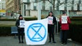 OLOMOUC, CZECH REPUBLIC, JANUARY 10, 2019: Extinction rebellion activist banner symbol circle hourglass is warning, men