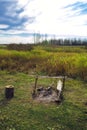 Extinguished bonfire in a field in a green meadow