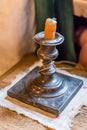 Extinguished candle in candlestick on wooden table Royalty Free Stock Photo
