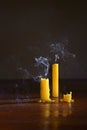 Extinguished candles on wooden table with smooth, white smoke from candles Royalty Free Stock Photo