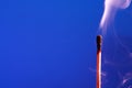 Extinguished Match On Blue Royalty Free Stock Photo