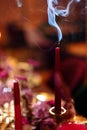 An extinguished red candle. Smoke from the wick. Christmas dinner. End of New Year`s Holidays. Selected focus and blurred Royalty Free Stock Photo